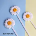 Close-up view of three white daisy resin cake toppers with yellow centers for baking - White Set (3 Pieces)