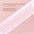 Macro view of 30pcs nude pink gradient press-on nail tips strip in XS, S, M sizes. - Nude Pink Gradient Glitter Elegant Style (S076-T) / 30 Packs