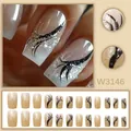 Detail view of ice transparent nude French press-on nails with black ribbon and silver glitter. - French Black Ribbon Glitter Style (W3146) / 24 Pcs/Set