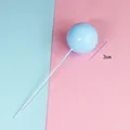 Close-up of a 3cm light blue round ball cake topper on a pink and blue background - 3cm (1 Piece) / Blue