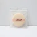 Soft peach ALYAN round powder puff with ribbon handle and subtle snowflake motif design - Nude