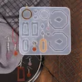 Macro view of geometric silicone resin mold with colorful finished earrings on a grid - White (60-213)