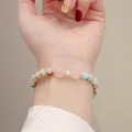 Detailed view of handmade natural Shoushan stone bracelet with heart-shaped pink quartz. - Shoushan Stone Rose Quartz Bowknot