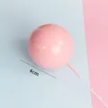 Detailed close-up of a 4cm pink matte metal ball cake topper decoration - 4cm (Pack of 5) / Pink