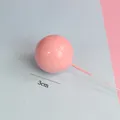 Close-up of a 3cm pink glossy ball cake topper decoration featuring a long thin metal stick. - 3cm (1 Piece) / Pink