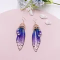 Elegante lila Schmetterlingsflügel-Ohrringe mit glitzernden Strasssteinen - Roségold - Blauer Strass