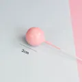 Close-up detail of a 2cm pink glossy metallic ball cake topper for birthday decoration - 2cm (1 Piece/Pack) / Pink