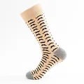 Close-up detail of a beige crew sock featuring a black mustache pattern and grey heel - One Size / Khaki Mustache