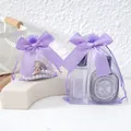 Detail view of purple organza gift bags with satin bow and drawstring closure - 9x12cm (Pack of 10) / Purple