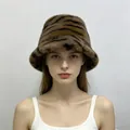 Detailed front view of a stylish tiger print faux mink fur bucket hat worn by a female model - One Size / Coffee Gray Tiger Print