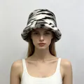 Close-up of a model wearing a stylish tiger-patterned faux mink fur bucket hat. - One Size / Gray White Tiger Print