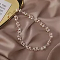 Detailed view of handmade freshwater pearl and crystal necklace on silky fabric - Necklace