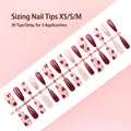 Macro detail of 30pcs heart pattern press-on nails in assorted XS, S, and M sizes - Red Heart Style (S134-T) / 30 Pcs/Strip / Red and Gold