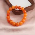 Detaillierte Makroansicht von lebhaften orangefarbenen Sonnensteinperlen auf Seide - 12mm Goldener Sonnenstein Stil / 12mm (ai-Einzelne Schlaufe)