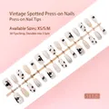 Detailed macro of 30-piece press-on nail strip featuring retro dots and silver glitter. - Retro Spotted Cow Pattern Style (S117-T) / 30 Pieces/Strip (Includes XS/S/M Sizes) / Cow Print/Silver