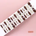 Set of 30 brown and gold glitter press-on nails with polka dot patterns on a display strip - Dark Coffee Gold Glitter Long Coffin Style (S089-T) / 30 Packs