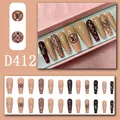 Detailed close-up of almond-shaped press-on nails with luxury brown monogram patterns and gems - 24 Pcs/Set / Dark Brown Nude Relief Vintage Monogram Style (D412)