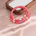 Elegant detail of pink beaded double-wrap bracelet with pearls on silk background - Double Loop Style / Rhodonite