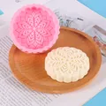 Detailed view of mooncake-shaped silicone mold with intricate floral pattern on a tray - Mandala Style (50-2685) / Pink