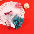 Detail view of a 12cm mini blue dried baby's breath bouquet for cake decoration - Blue Baby's Breath
