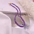 Detailed shot of purple amethyst beaded necklace with gold lobster clasp and pearl - Amethyst / Purple
