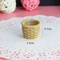 Detailed view of miniature yellow resin woven basket with 2.2cm and 2.7cm dimensions - Bamboo Basket