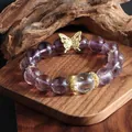 Close-up detail of a natural 12mm amethyst bead bracelet featuring a gold butterfly charm - Purple Butterfly Crystal Bracelet 12mm