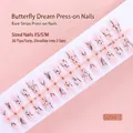 Close-up of butterfly and branch patterns on sparkling press-on nail strips - Nude Fine Glitter Freehand Butterfly Style (S094-T) / 30 Packs