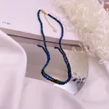 Macro view of faceted blue natural stone beads with gold extension chain and pearl detail - Malachite / Dark Green