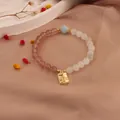Elegant natural strawberry quartz and moonstone beaded bracelet with a gold luck charm pendant - Fortune and Prosperity Style