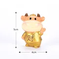 Small golden resin cow figurine for cake topper and home decor, 5cm high and 4cm wide - Wealth Ox