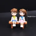 Cute couple figurines sitting on a bench for cake decoration and wedding gifts - Blue and Yellow Stool Couple