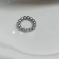 Detail of a grey pearl beaded ring featuring a square crystal center stone on white - Light Gray