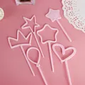 Detailed view of pink plastic cake toppers in heart, crown, and star shapes for baking. - Star Crown Balloon Topper - Pink
