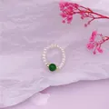 Elegant freshwater pearl ring with a central green bead and gold accents - Green Jade