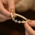 Close-up detail of a freshwater pearl bracelet with moonstone accents and gold beads. - Moonstone-Gold Rice Freshwater Pearl