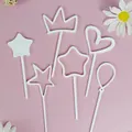White plastic cake toppers set in heart, crown, and star shapes - Set / White