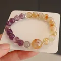 Macro detail of natural amethyst and citrine crystal beaded bracelet on white card - Natural Yellow Pagoda Crystal and Amethyst