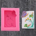 Pink silicone mold and painted butterfly flower plaster casting on dark background. - Flower Vine Butterfly Pink (50-1674-A)