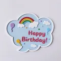 Close-up detail of soft rubber cloud cake topper with rainbow and Happy Birthday text decoration - Blue Writable Rainbow Topper / Blue