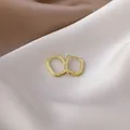 Detailed view of elegant gold geometric rectangular hoop earrings resting on soft satin - 6# 16426 Oval / Gold