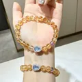 Elegant natural citrine crystal beaded bracelet featuring a sparkling blue heart charm on wrist - Yellow Tower Crystal Gourd Style / 8mm Bead