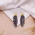 Elegante lange Brautohrringe mit Schmetterlingsflügeln und glitzernden Strasssteinen - Gold-Schwarz