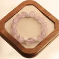 12mm natural lavender amethyst bead bracelet with silver spacers on display - Light Amethyst Bracelet