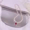 Detailansicht einer Vintage-Süßwasserperlenkette mit rotem Zirkonia-Tropfenanhänger - Roter Strass-Tropfen-Stil / Silber