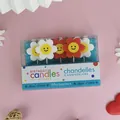 Close-up detail of a 5-piece pack of colorful smiley face flower birthday cake candles - Red and White Flower Style (红白花蜡烛) / Pack of 5