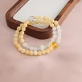 Detailed view of a handmade double-strand golden silk jade and citrine beaded bracelet - Double Wrap Bracelet / Topaz Green Jadeite Running Ring Bracelet