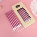 Twelve metallic purple slender pencil birthday candles presented in a kraft paper box - 12 PCS / Pink