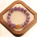 Purple natural amethyst 12mm bead bracelet with yellow accents on a wooden display tray - Ametrine Spinning Ring Bracelet