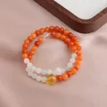Elegant double-strand beaded bracelet with orange and white gemstones on silk. - Double Wrap Bracelet / Sunstone Green Jadeite Running Ring Bracelet